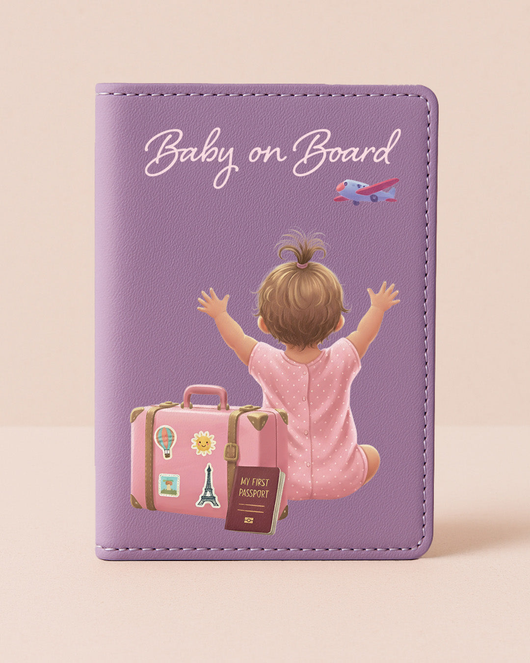 Purple card with illustration of a baby on a suitcase and 'Baby on Board' text on a beige background