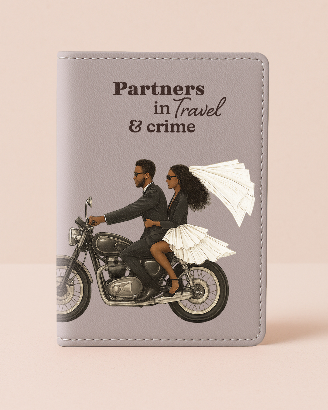 Passport holder with illustration of a couple on a motorcycle and text 'Partners in Travel & crime' on a beige background