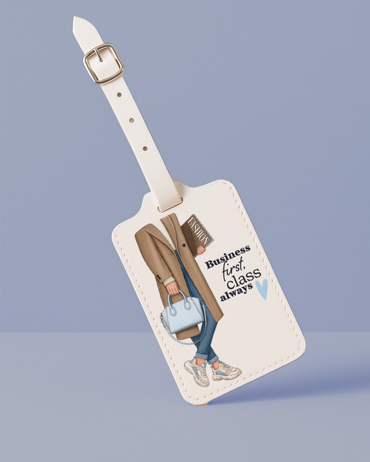 Luggage tag with a design of a person holding a suitcase and text 'Business first class always' on a light blue background.