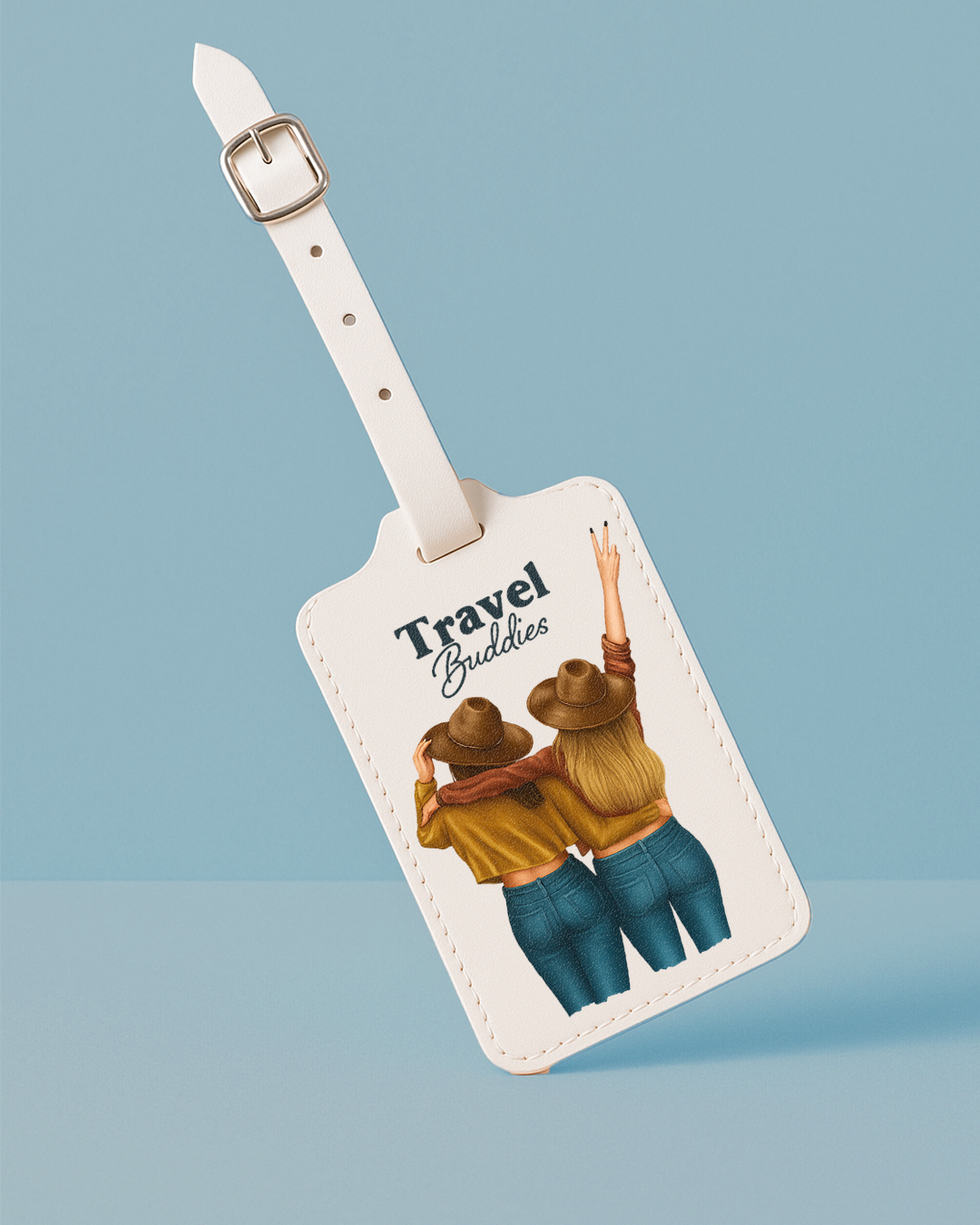 Luggage tag with illustration of two people hugging and 'Travel Buddies' text on a light blue background