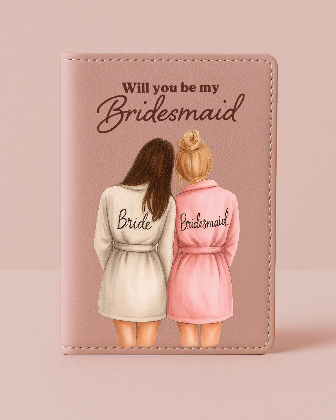 Card with illustration of two women in robes labeled 'Bride' and 'Bridesmaid' on a pink background.